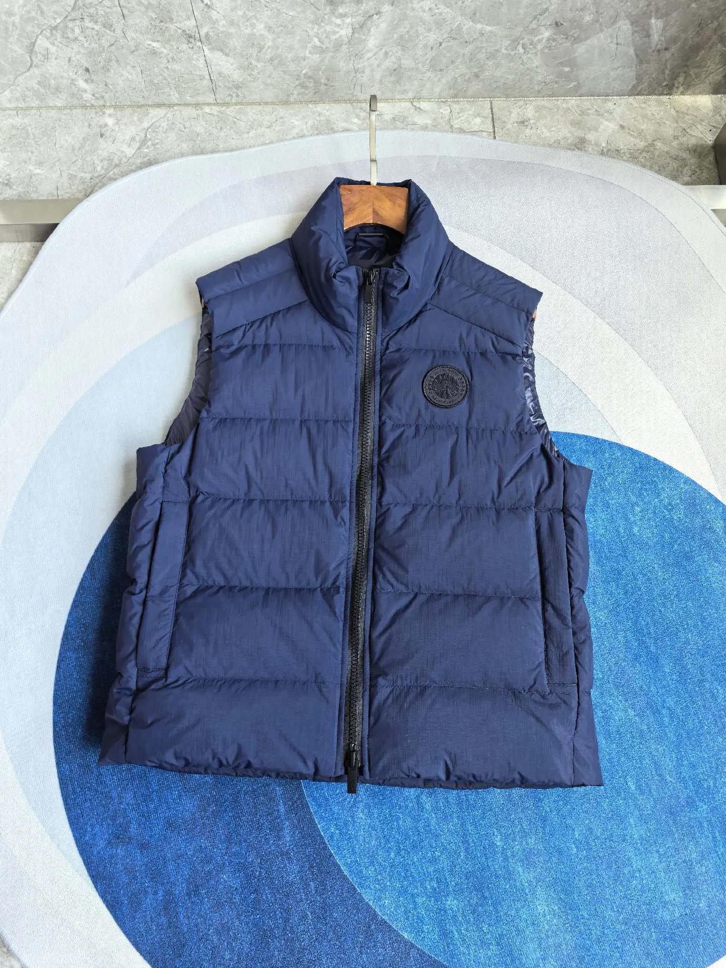 Style number: Y MB style Crofton men's black label down vest. This vest is lightweight and easy to fold and store, making it an ideal travel companion. This piece is made from sustainable materials and treated to be water-repellent, making it Wear-Resistant. Features zippered hand pockets lined with tricot. Color: Dark Blue Size: S M L XL XXL